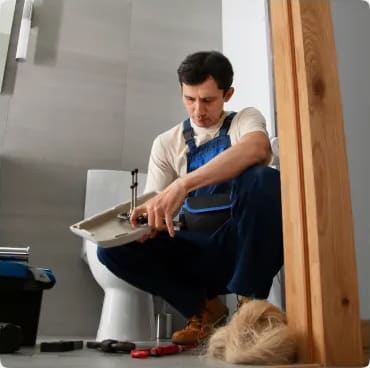 Plumber installing a toilet during a bathroom remodel